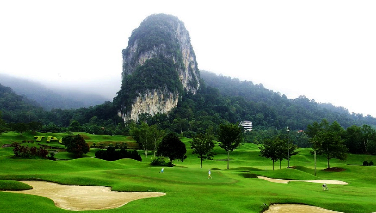 The limestone mountains at Templer Park Golf Course shrouded in mist.